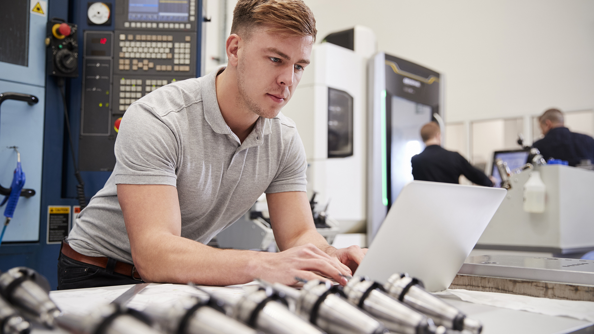 Male Engineer Using CAD Programming Software On Laptop